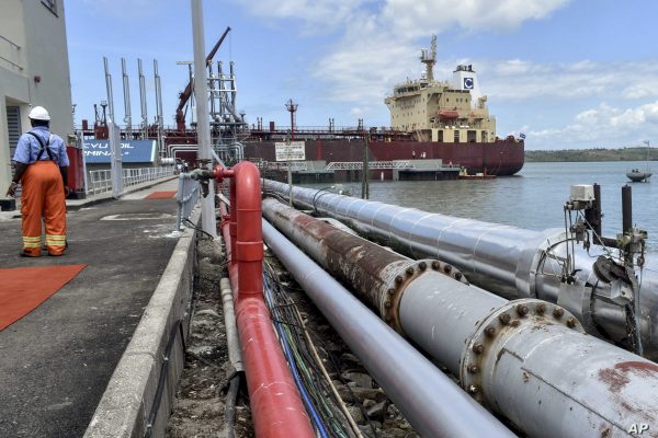 The Celsius Riga tanker carrying Kenya-produced crude oil, sits docked during a ceremony at the Kipevu oil terminal at the port in Mombasa, Kenya, Monday, Aug. 26, 2019. Kenya's President Uhuru Kenyatta flagged off the country's first pilot shipment of oil on Monday and the country expects to start full-scale commercial oil production export in 2024. (AP Photo)
